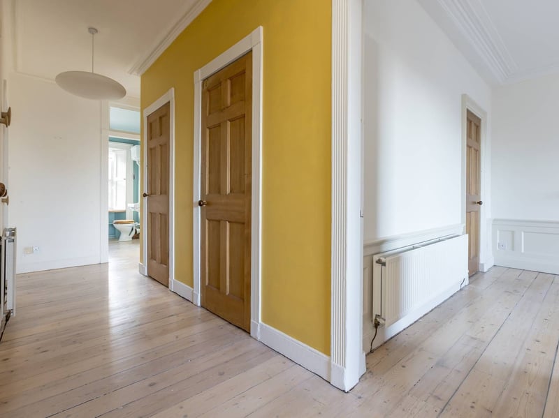 The entrance hall, with handy storage cupboards.