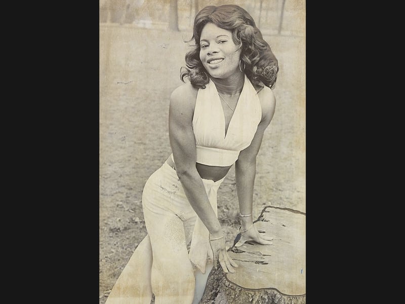 Twenty-two-year-old Vinetta Miller, a nurse at the Manor Hospital in Walsall, poses stylishly outdoors in February 1974. Originally from Jamaica, Vinetta admitted she missed the Caribbean sunshine back home but thoroughly loved living and working in Britain, filling her spare time with dancing, music, walking, and designing and stitching her own fashionable clothes. Her warm presence reflected the dedicated overseas NHS staff who brought vital care and vibrant spirit to local hospitals throughout the Black Country. Did you work alongside Vinetta Miller at the Manor Hospital or remember being treated by the dedicated nursing staff in Walsall during the 1970s?