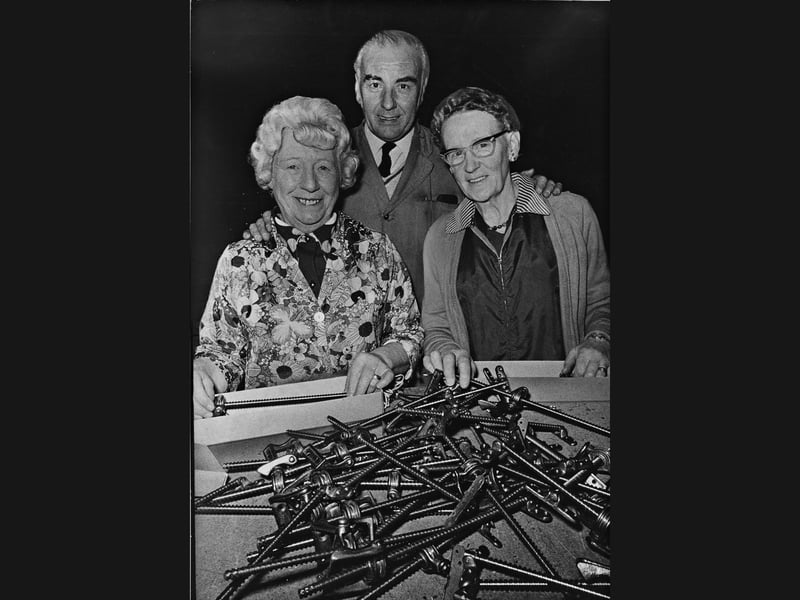 Warehouse packers Mary Wilson (40 years' service) and Edith Richard (33 years' service) gather alongside warehouse foreman Bob Barbridge (28 years' service) over boxes of hardware fittings at Hope Works Ltd in December 1974. Based on Pleck Road, the historic Walsall firm specialised in architectural hardware, fittings, and antique-style ironwork destined for export markets around the world. With more than a century of manufacturing tradition behind it, the company recently presented gold watches to 29 long-serving staff who had each completed 25 years on the clock, celebrating a rare standard of Black Country workplace loyalty. Did you or a family member work at Hope Works on Pleck Road, or remember receiving a company presentation watch back in 1974?
