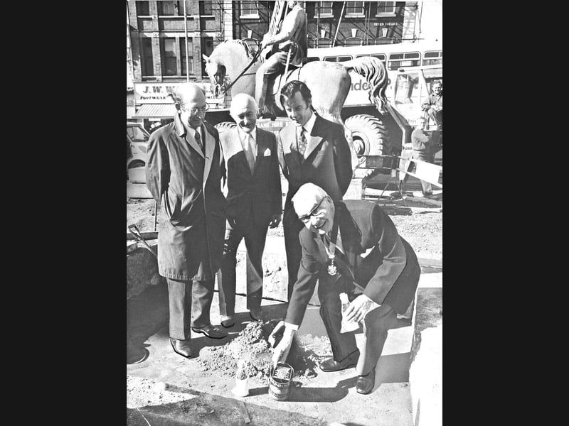 Wolverhampton’s deputy mayor, Councillor Ted Lane, kneels to deposit a time capsule beneath the foundations of the Prince Albert equestrian statue in September 1974. Watching on (from left) are Ronald James (deputy director of technical services), Geoffrey Smith (managing director of stonemasons W Hopcroft and Son), and Michael Duffell (assistant town clerk). The much-travelled statue was returning to its original Queen Square resting place after 23 years, and to mark the homecoming, a Banks’s beer can was packed with decimal coins, Express & Star press photographs, and two bottles of Banks's Wedding Brew Strong Ale before being buried for future generations. Do you remember watching Prince Albert being moved back to the centre of Queen Square in September 1974?