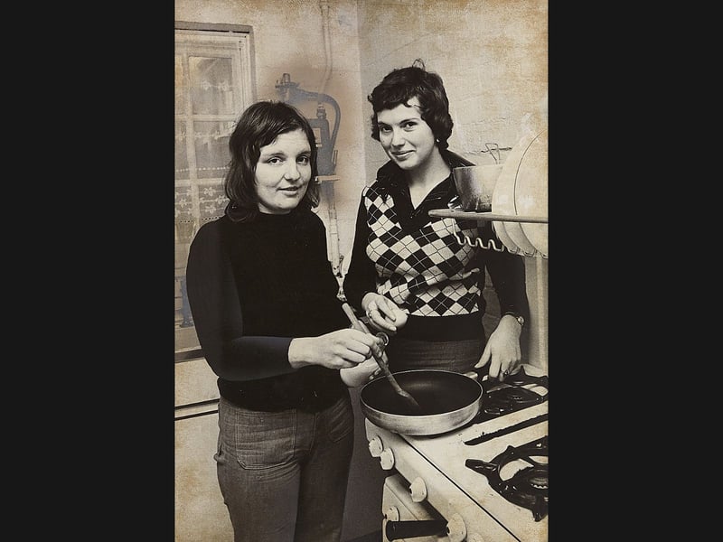 Standing over a frying pan in the kitchen, 23-year-olds Catherine Cairns and Susan Harris prepare a meal at a terrace home in Tennyson Road, Wolverhampton, in January 1974. The two university graduates volunteered as resident organisers for the Haven Project—a pioneering local initiative set up to provide a safe refuge and supportive family environment for young homeless women aged 17 to 25. Supported by house cat Samson, funded through charitable trusts, and operating for just £3 a week pocket money, Catherine and Susan helped turn the council-rented property into a welcoming, shared haven where residents shared daily chores and found their feet. Do you remember the opening of the Haven Project on Tennyson Road, or recall the early days of the women's shelter scheme in Wolverhampton back in 1974?