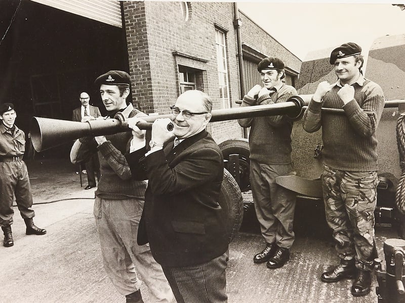 Shouldering the hefty weight of an L70 anti-aircraft gun barrel alongside soldiers, Wolverhampton Mayor Councillor Sam Reynolds gets hands-on during an official tour in April 1975. Visiting the Territorial Army Centre at Wolseley House in Fallings Park, the Mayor joined troops from the 210 Staffordshire Light Air Defence Battery as they demonstrated the physical drill required to quickly swap out the heavy gun barrel. The visit highlighted the rigorous training of local volunteer reservists stationed in Wolverhampton during the Cold War era. Were you serving with the 210 Staffs Light Air Defence Battery at Wolseley House, or do you remember Councillor Sam Reynolds during his mayoral year in the mid-1970s?