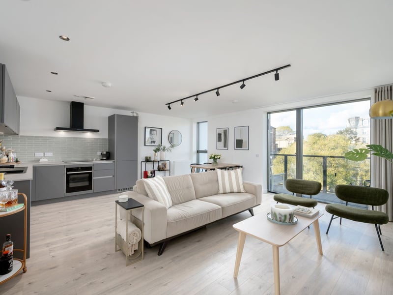 The living/dining room is open plan to a bespoke kitchen, creating a contemporary environment.