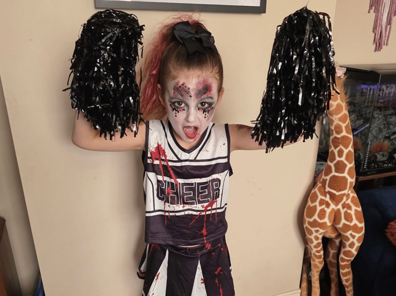 Six-year-old River as an undead cheerleader.