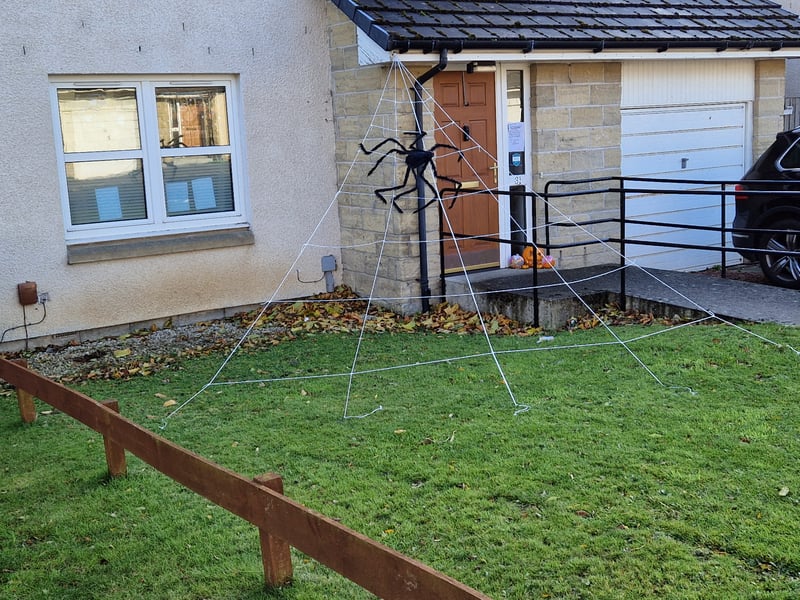This giant spider hangs over this Redhall home this Halloween.