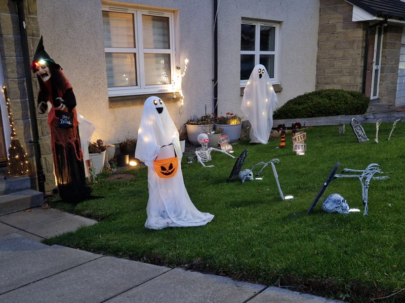 A scary witch and some spooky ghosts guard this front garden in Redhall.