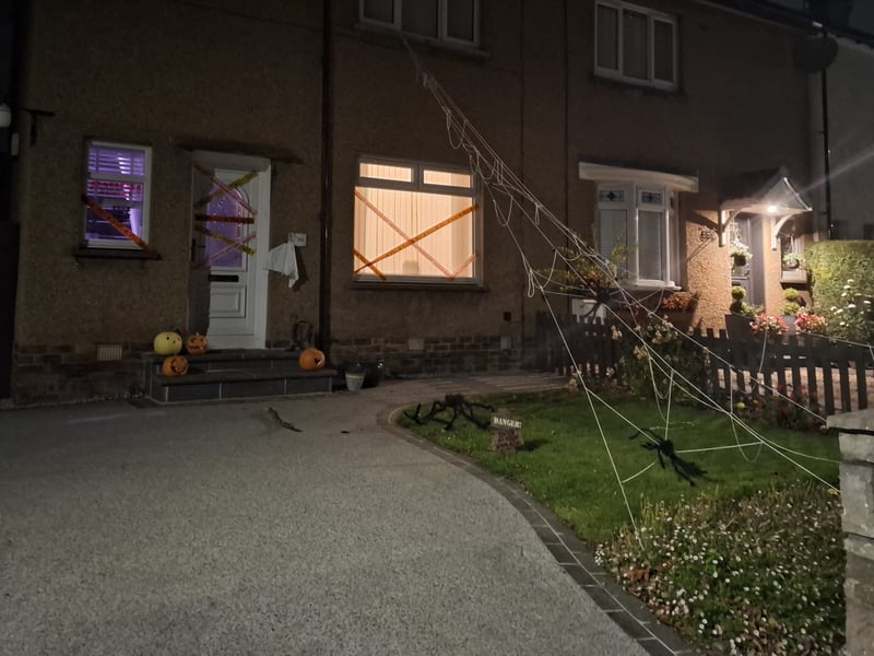 This Halloween home in Danderhall is caught in a large spider's web.