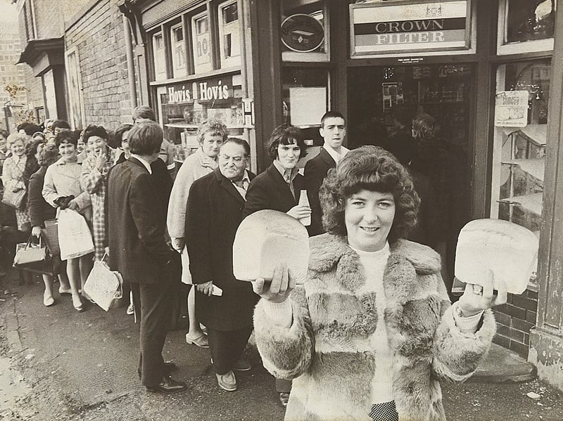 Christine Clarke of Dalkeith Street, Walsall, proudly holds aloft two hard-won loaves of bread after queuing outside Jones bakery in early December 1974. A nationwide bakers' strike triggered a wave of panic buying across the West Midlands, with hundreds of eager shoppers lining pavements for hours outside local bakeries and stores just to secure daily staples. In some towns the scramble boiled over into utter chaos, but for those patient enough to brave the December queues, walking away with fresh bread felt like striking gold. Do you remember joining the long queues during the 1974 bread strike, or recall how your family coped during the shortages?