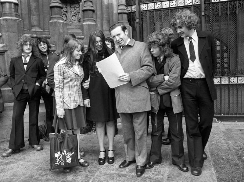 Solicitor General and Warley West MP Peter Archer, QC, reviews papers alongside visiting schoolchildren from Cradley Heath outside the Palace of Westminster on 15 July 1974. Sporting classic 1970s wide-collared suits, flares, and even a Mickey Mouse tote bag, the youngsters enjoyed a memorable educational day trip from the Black Country to tour the corridors of power at the House of Commons. Were you among the Cradley Heath students who travelled to London to meet your local MP at Parliament in the summer of 1974?