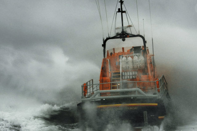 Clifden RNLI volunteers battled four-metre swells to tow three sailors to safety after their yacht suffered engine failure.