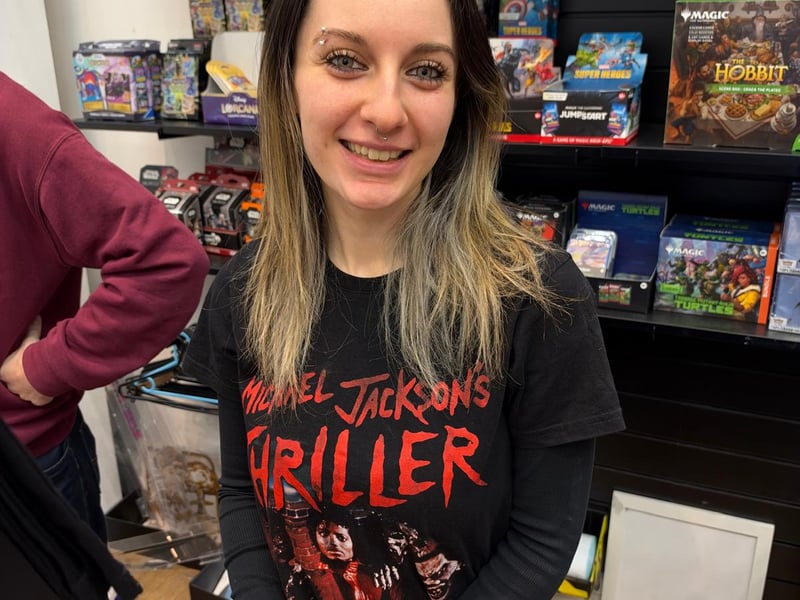 A shop worker celebrates with Michael Jackson's Thriller