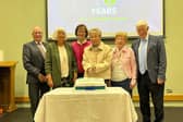 Founder members gathered around Mrs Hazel Williamson for the cake-cutting ceremony.