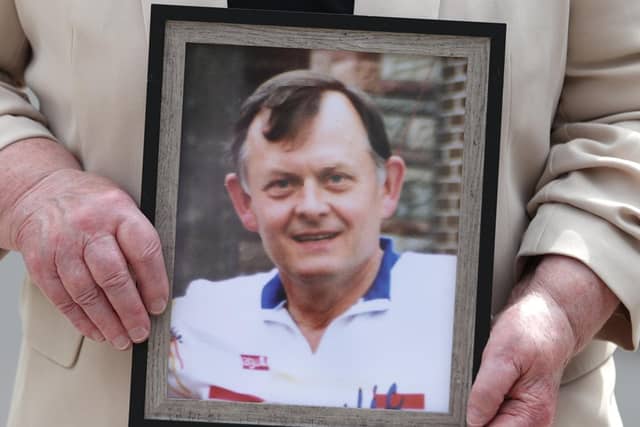 Bridie Brown, the widow of Sean Brown, holds a photograph of the murdered GAA official.