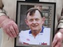 Bridie Brown, the widow of Sean Brown, holds a photograph of the murdered GAA official.