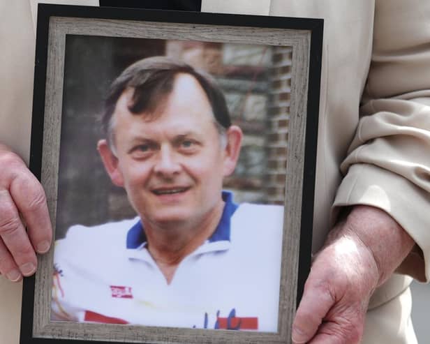 Bridie Brown, the widow of Sean Brown, holds a photograph of the murdered GAA official.